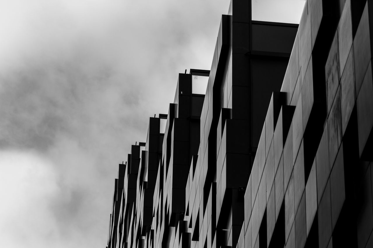 LOW ANGLE VIEW OF BUILDING AGAINST CLOUDS