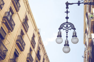 Low angle view of street light against building