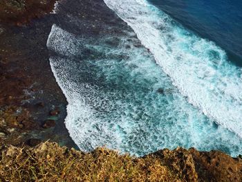 High angle view of waves reaching shore at beach