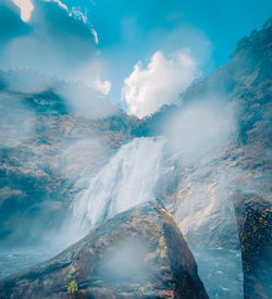 Aerial view of waterfall against sky