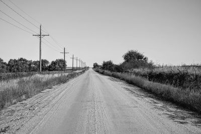 Empty road along countryside landscape