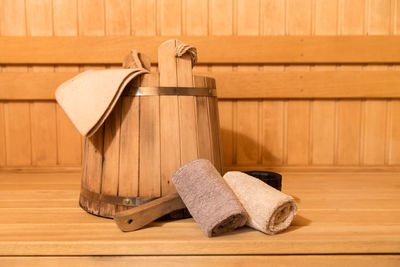 Close-up of bucket and towels in sauna