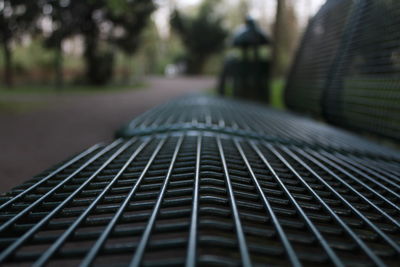 Close-up of empty benches in park