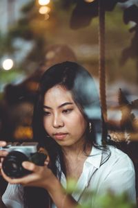 Portrait of young woman looking away outdoors