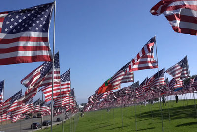 Low angle view of flags flag against sky