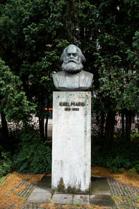 Statue against trees and plants