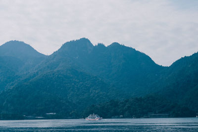 Scenic view of sea and mountains against sky