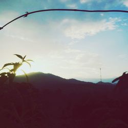 Scenic view of silhouette mountains against sky