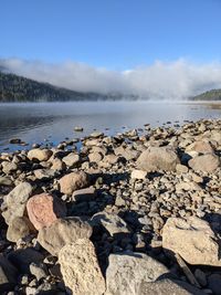 Rocks on beach against sky