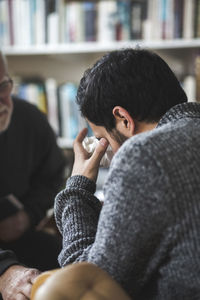 Doctor explaining sad male patient during therapy session