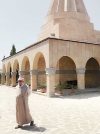 Woman sitting outside temple