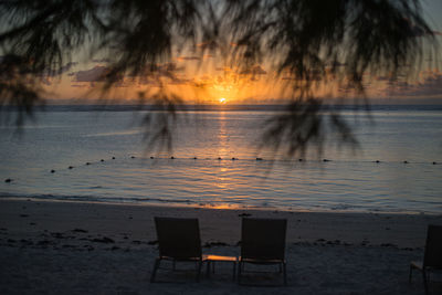 Scenic view of beach against sky during sunset