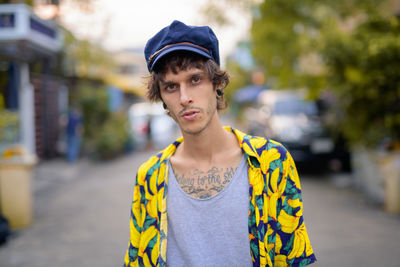 Portrait of young man standing on street