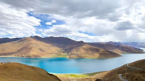 Scenic view of lake against cloudy sky