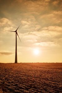 Wind turbine on sunrise, rotating propeller in gentle wind