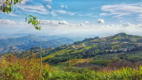 Scenic view of mountains against cloudy sky