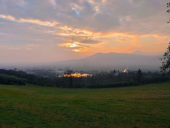 Scenic view of field against sky during sunset