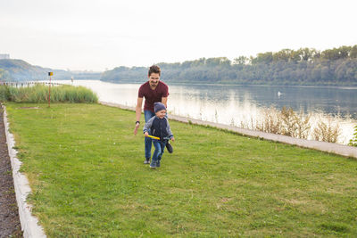 Full length of man on lake against plants