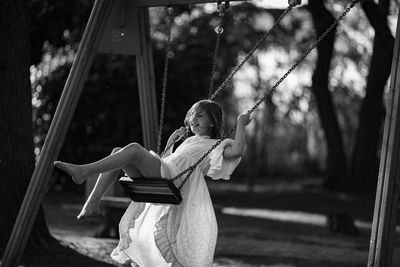 Portrait of girl on swing at playground