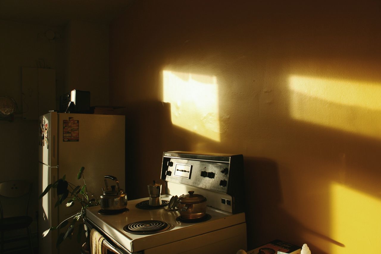 indoors, illuminated, table, no people, high angle view, home interior, technology, wall - building feature, absence, built structure, architecture, chair, still life, house, domestic room, night, interior, wall, room, communication