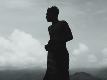 Low angle view of silhouette man standing against sky