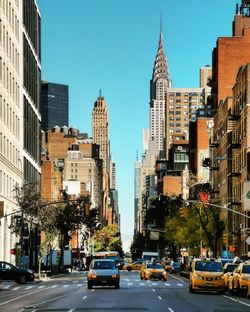 View of city street and buildings against sky