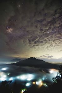 Scenic view of mountains against sky at night