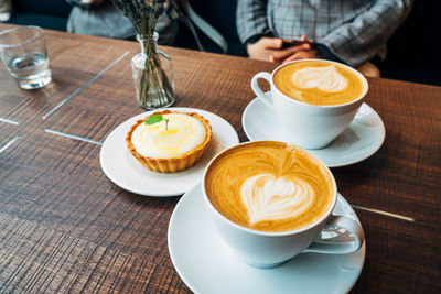 Close-up of coffee cups on table