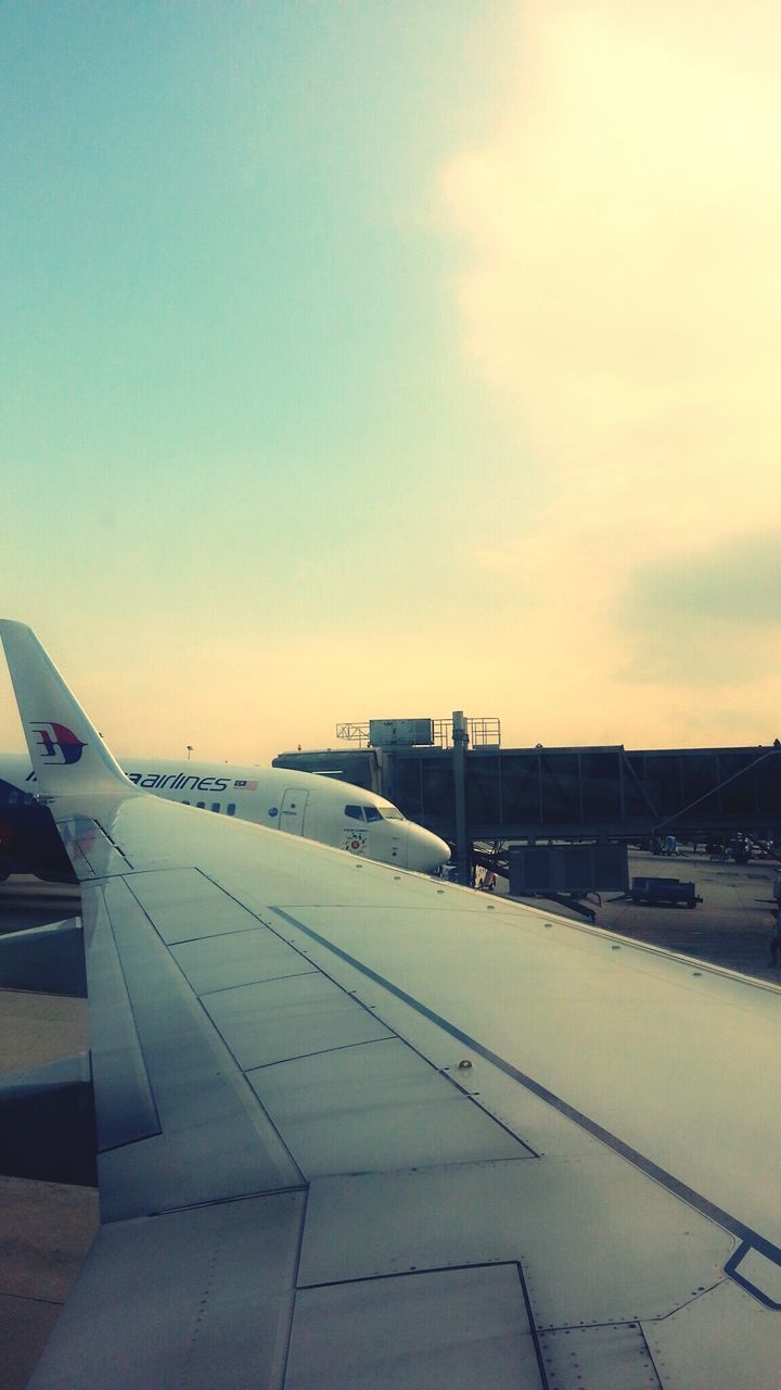 transportation, mode of transport, airplane, sky, aircraft wing, air vehicle, cropped, sunset, public transportation, flying, travel, sea, part of, cloud - sky, nature, journey, outdoors, no people, built structure, scenics