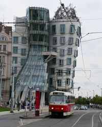 Cars on street in city against sky