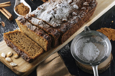 Pumpkin sponge cake cut into slices with powdered sugar on top