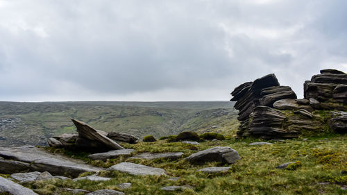 Scenic view of rocks on land against sky