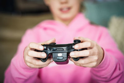 Close-up of girl holding pink camera