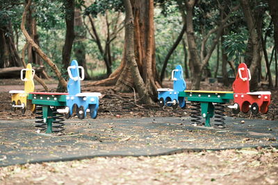 Rear view of people sitting on footpath