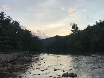 Scenic view of river against sky at sunset