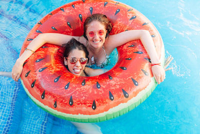 Portrait of a smiling young woman in swimming pool