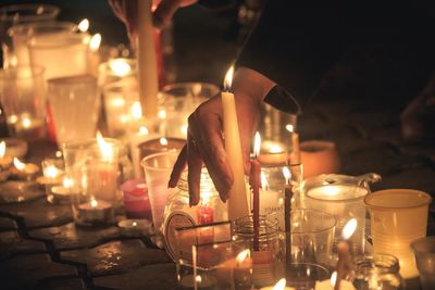 Illuminated tea light candles on table