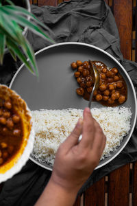 Midsection of person holding food in bowl