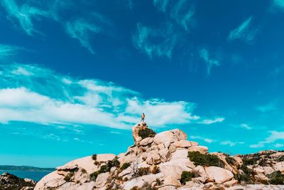 Low angle view of rock formation against blue sky