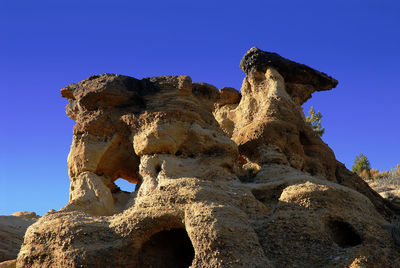 Rocky structure against clear sky