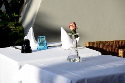 Flower vase on table against wall
