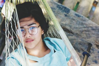 Portrait of young woman resting in hammock