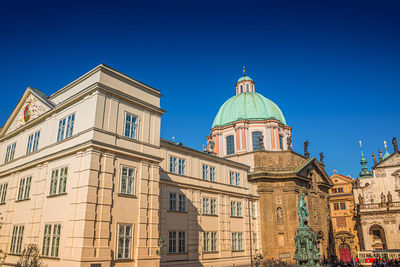 Low angle view of buildings against clear blue sky