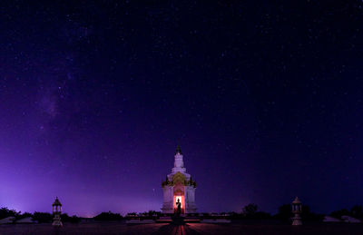 Low angle view of illuminated building against sky at night