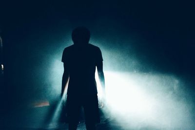 Low angle view of silhouette people standing against sky