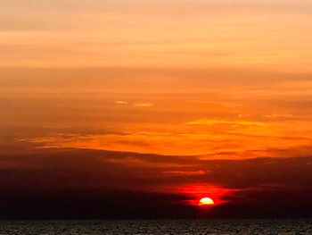 Scenic view of sea against romantic sky at sunset