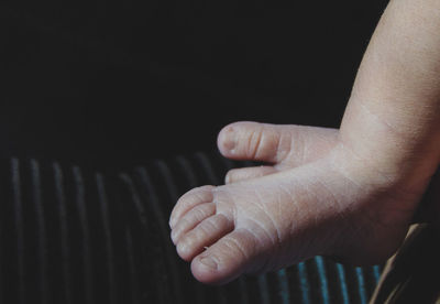 Close-up of human hand against black background