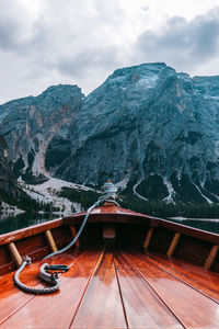 Boat on lake against mountain during winter