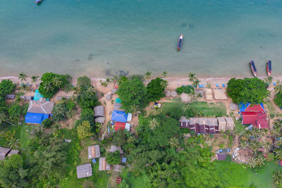 High angle view of buildings and trees by sea