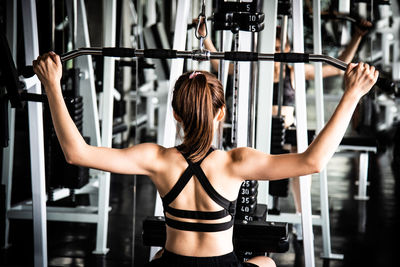 Young woman exercising in gym